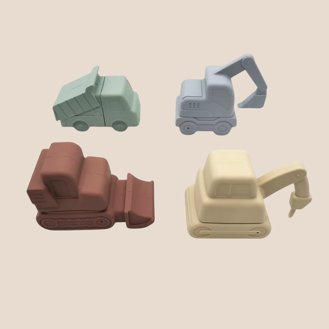 Four toy construction vehicles in different colors on a beige background