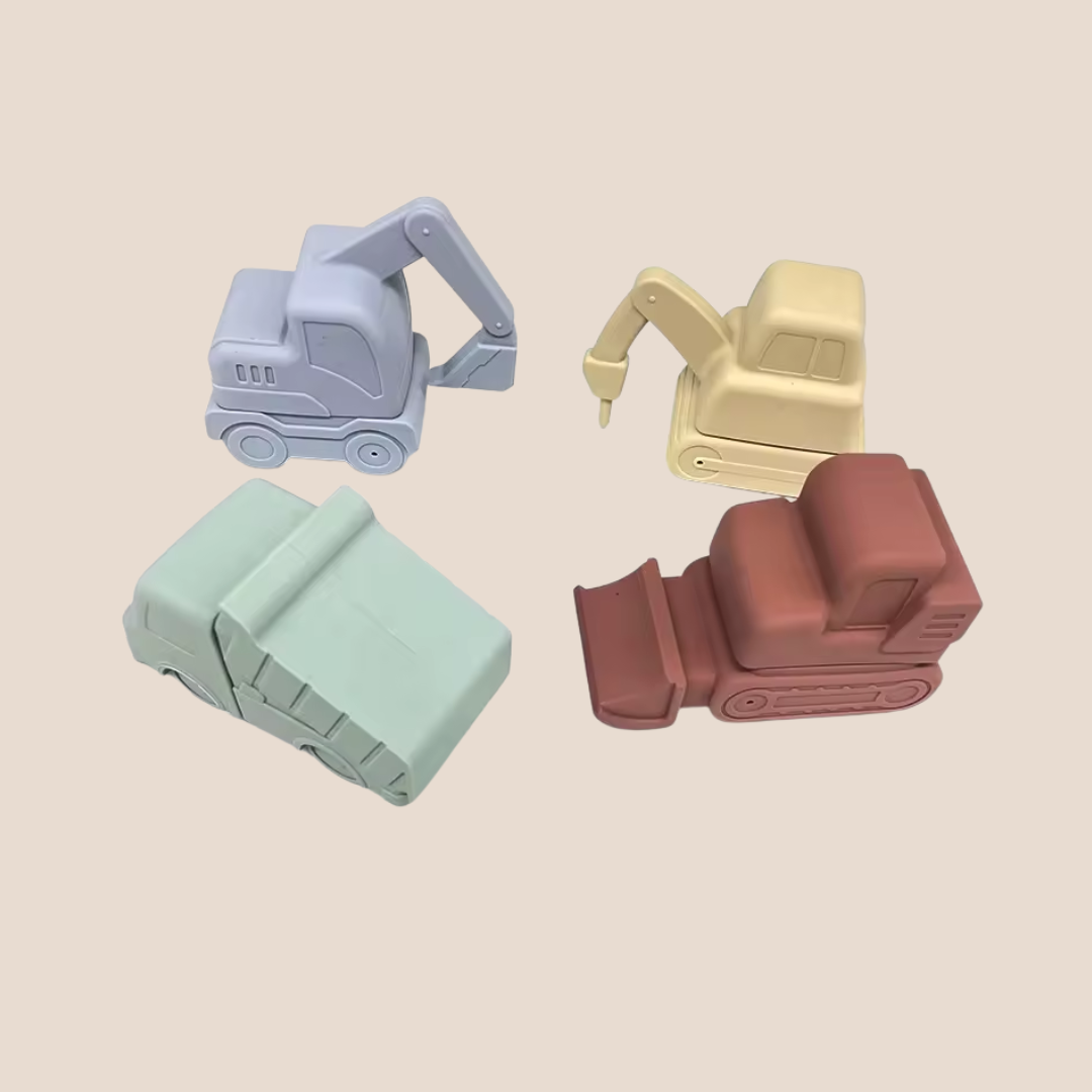 Four toy construction vehicles in different colors on a beige background