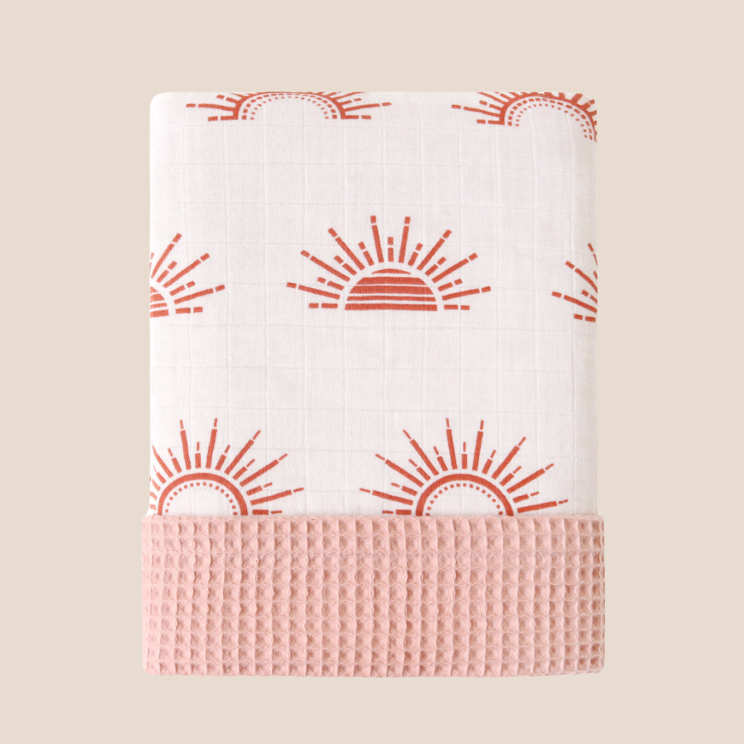 Folded rising sun baby blanket with peach waffle side – reversible muslin and cotton blanket for newborns
