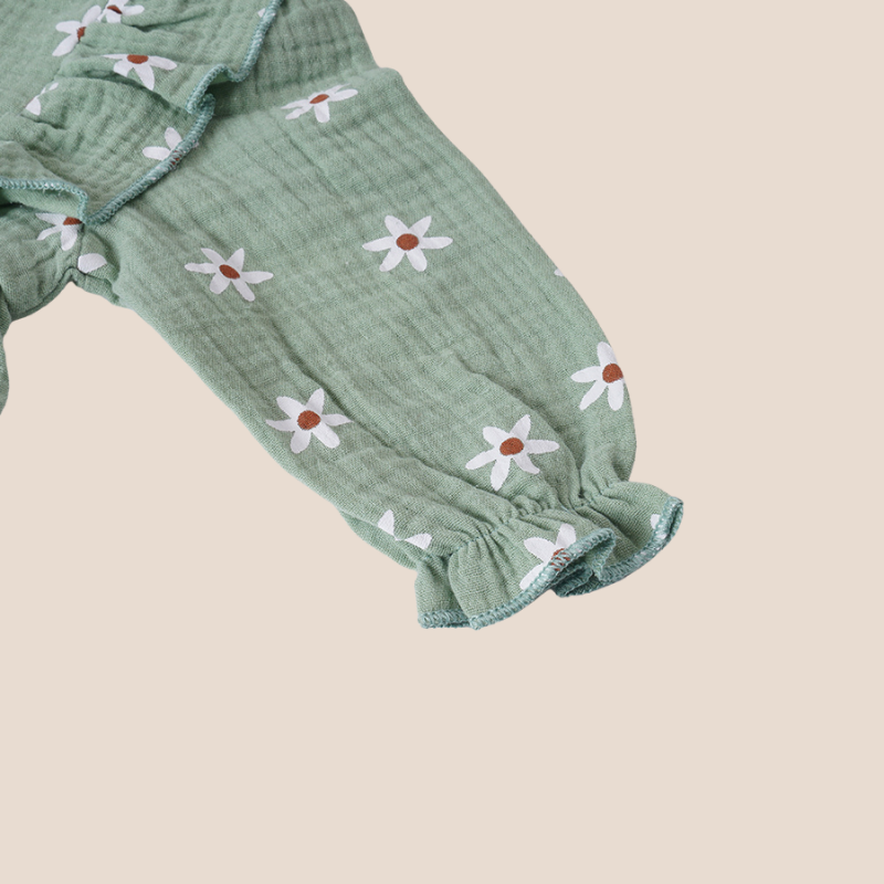 Sleeve close-up of baby romper with elastic cuff and daisy print