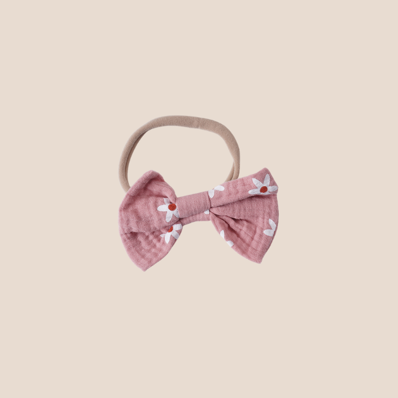 Back button closure on daisy baby romper with pink muslin fabric