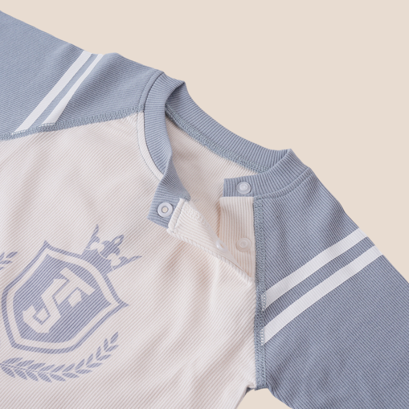 Baby boy ribbed romper with printed crest and blue collar snap closure