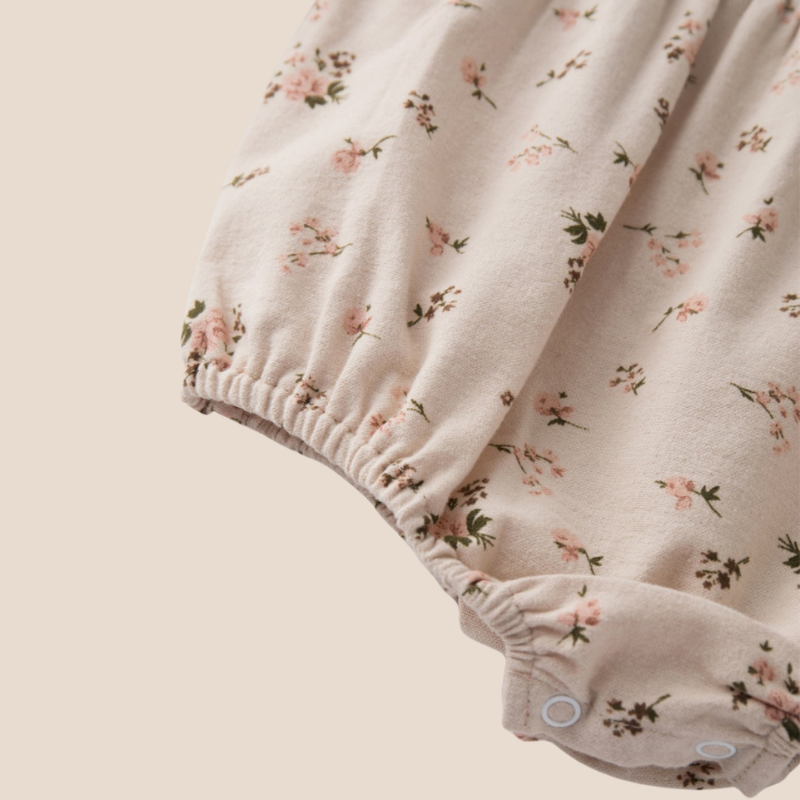 Bottom snap closure and gathered skirt of baby dress romper