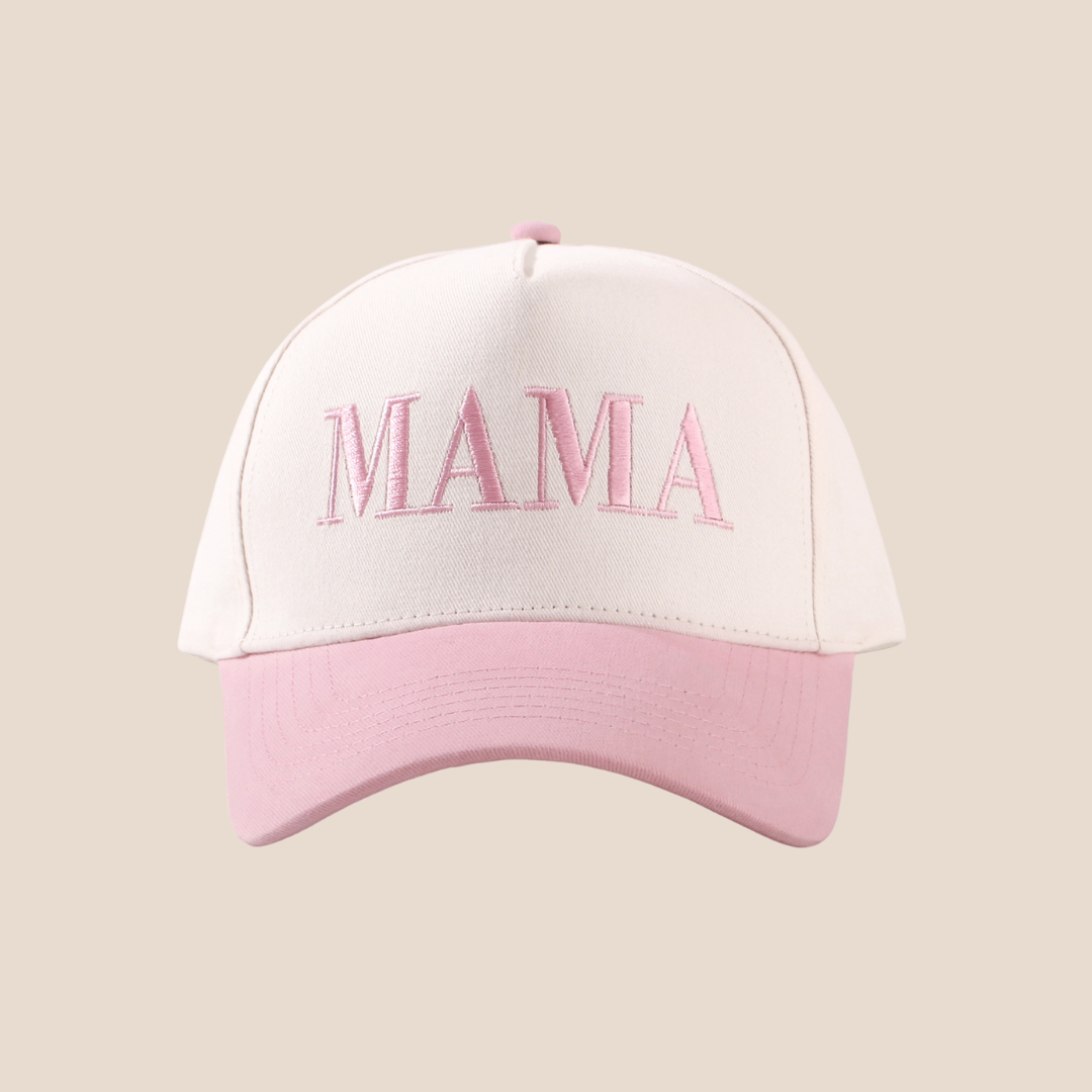 White and pink cap with 'MAMA' embroidery on a beige background
