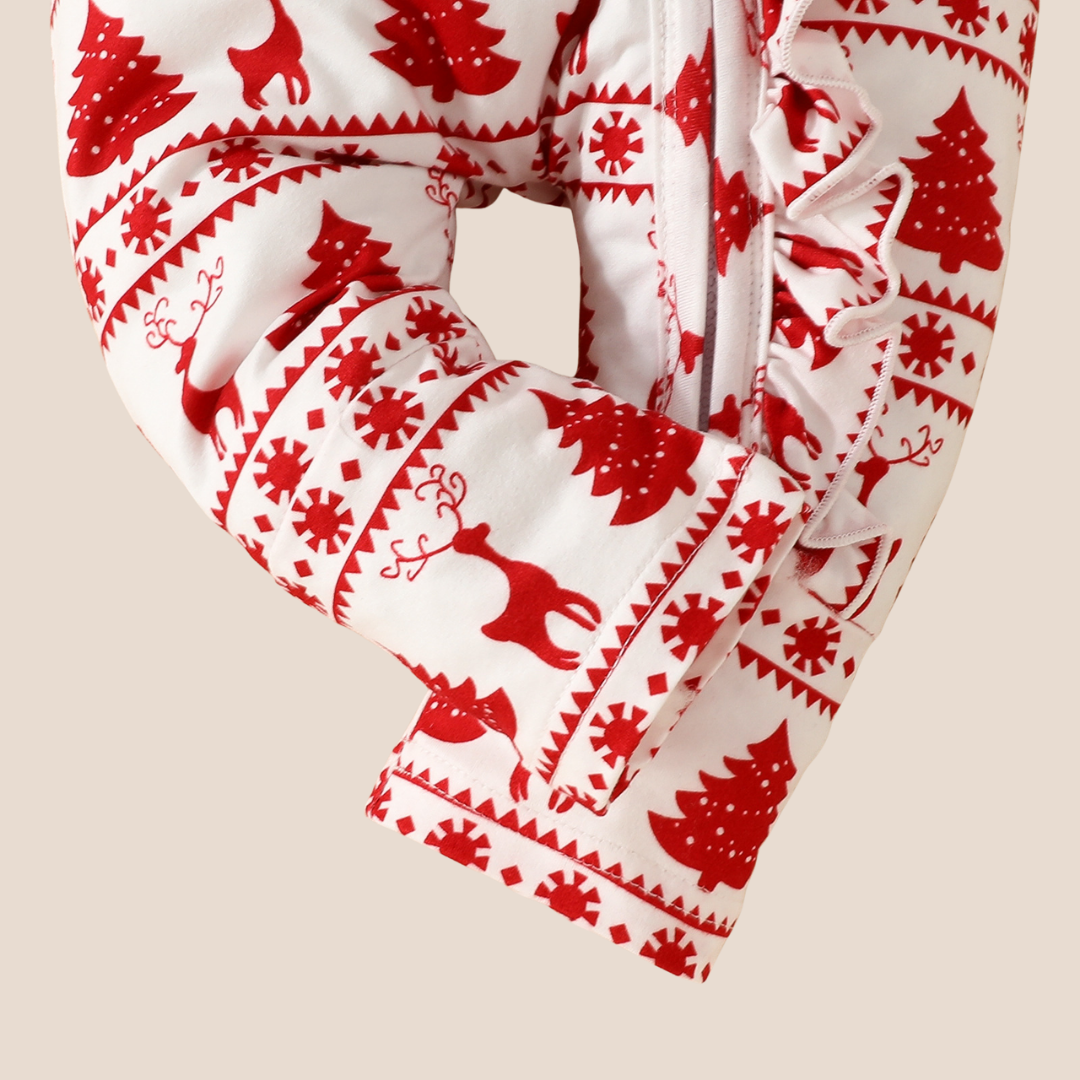 Red and white patterned fabric with reindeer and trees on a beige background