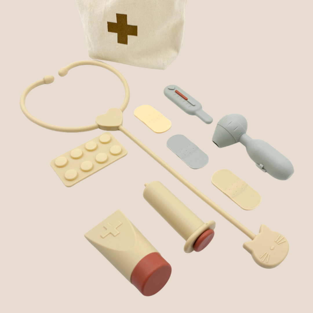 Canvas tote with silicone doctor tools for pretend play in modern neutral colors including syringe, bandages stethescope all made with silicone.