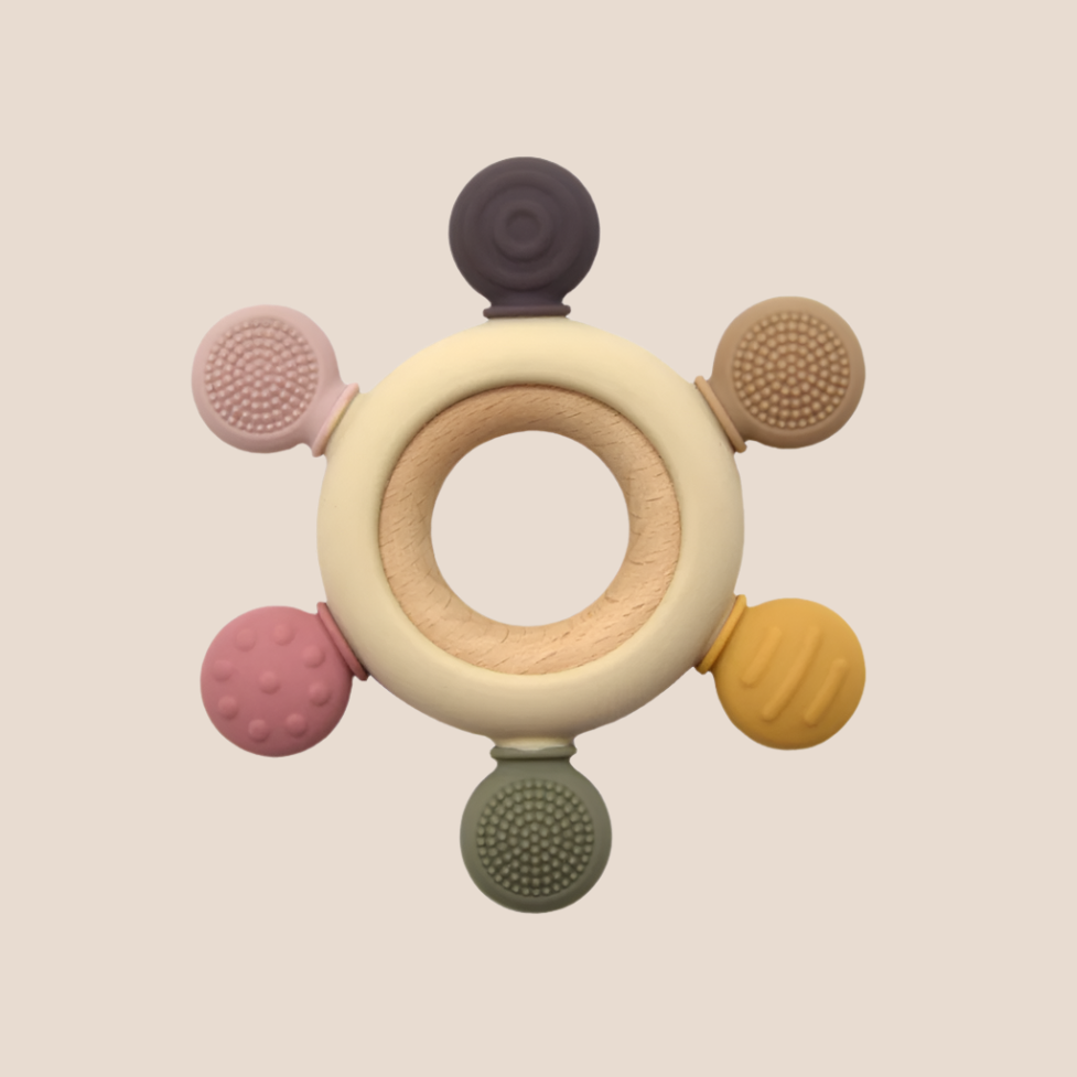 Natural beech and silicone baby teether close up pink and beige
