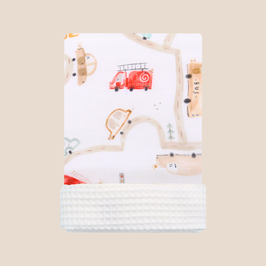 Baby blanket with red truck and wooden toys design on a beige background