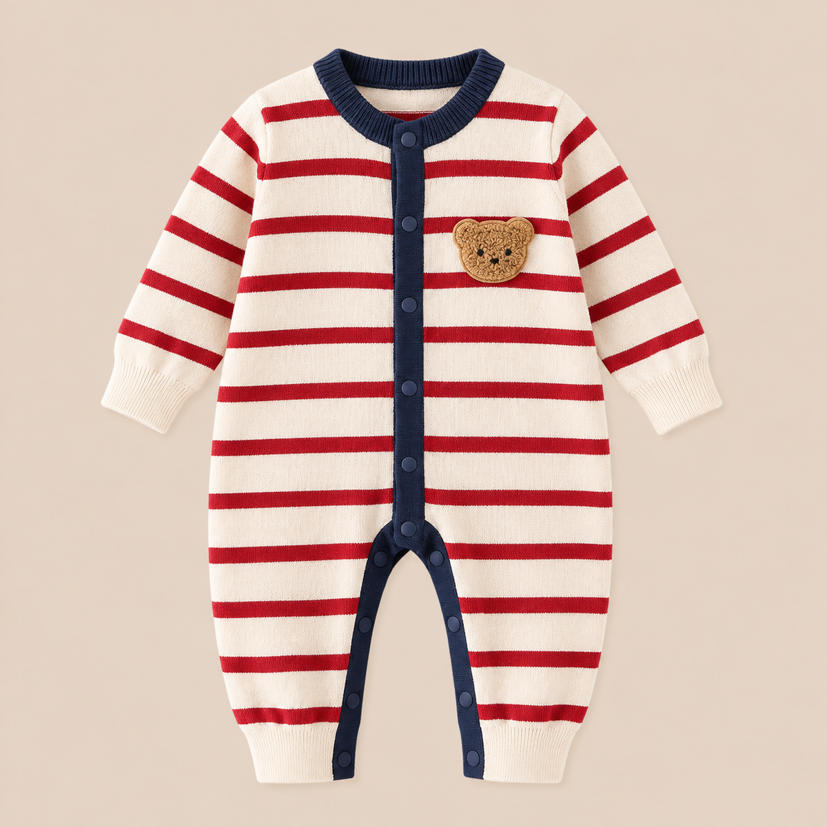 Front view of red and cream striped knitted baby romper with teddy bear appliqué and snap-button closure.