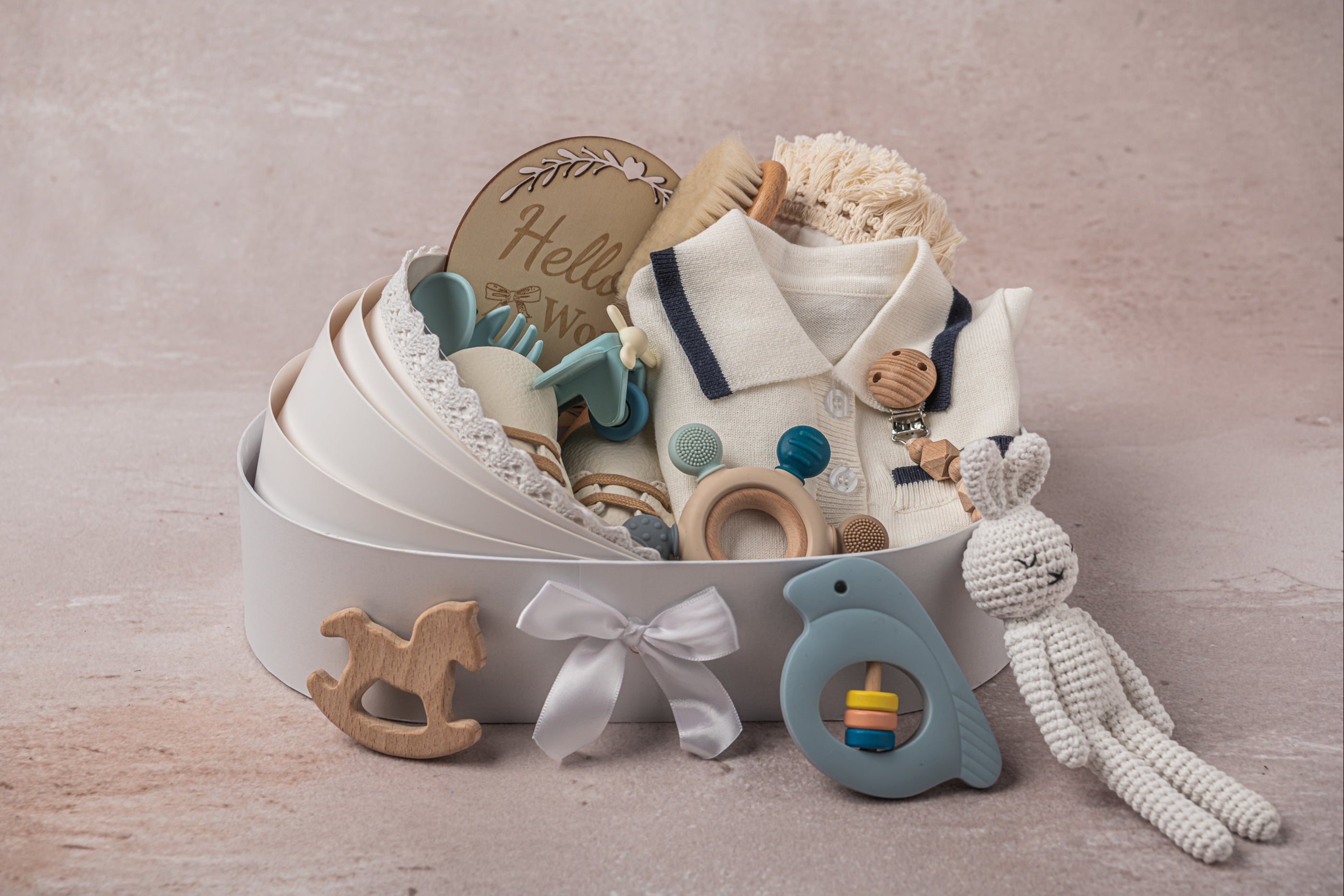 Elegant baby boy gift basket in a crib-inspired keepsake box, featuring handcrafted newborn essentials, plush toys, and BPA-free silicone feeding accessories