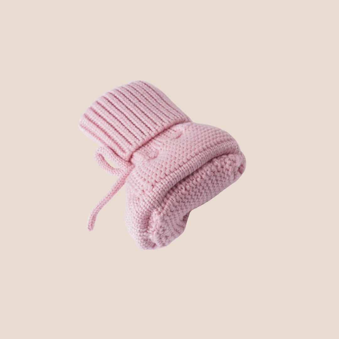 Close-up sole of pink baby booties showcasing premium knit finish – thoughtful essential for personalized baby girl gifts, baby showers, and curated client gift hampers.