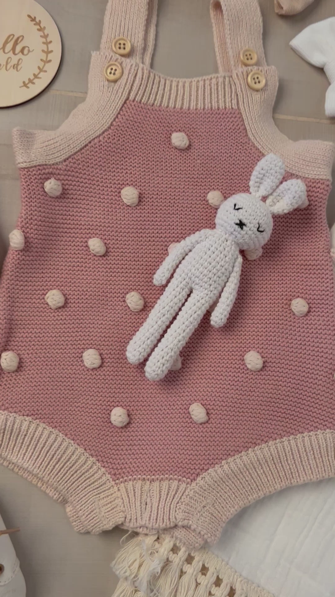 Short video showcasing two luxury baby gift sets—one in blush pink with a polka-dot knit romper, matching headbands, baby shoes, and a crochet bunny; the other in soft beige featuring a long-sleeve knit bodysuit, bear ear hat, and wooden toy—all presented in an elegant bassinet-shaped gift box. Perfect for baby showers, newborn welcome gifts, or eco-conscious gifting. High-quality, customizable, and beautifully curated.