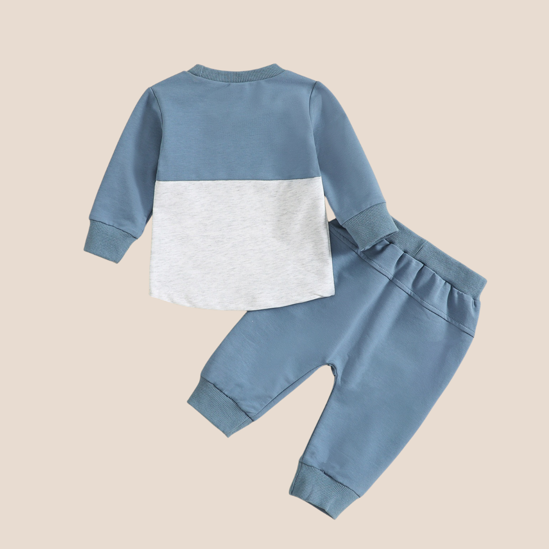 Children's two-tone blue and gray outfit on a beige background