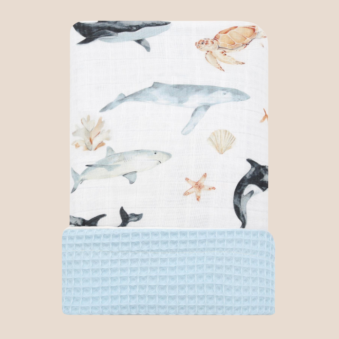 Folded ocean baby blanket with sea animal bamboo muslin and blue waffle cotton – reversible newborn blanket