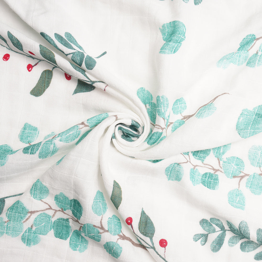 Close-up of bamboo muslin fabric featuring eucalyptus leaves and berries – breathable swaddle for baby gifting, perfect for eco-conscious moms and luxury personalized baby gift boxes.