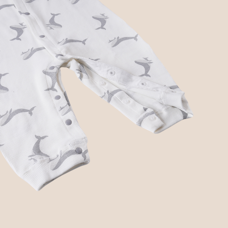 Snap leg closure detail of breathable cotton whale print romper
