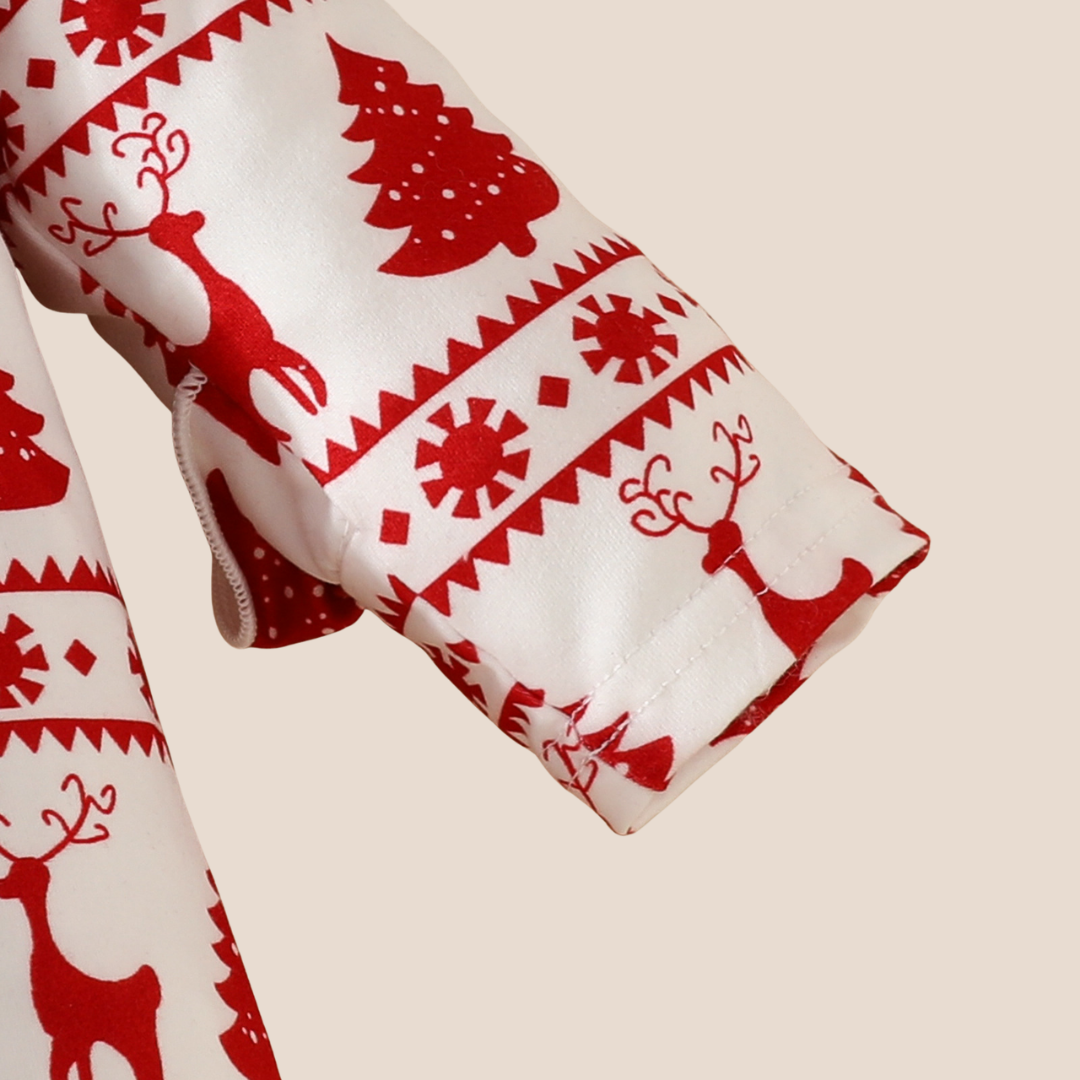 Detailed view of romper sleeve showing festive pattern and soft stitching