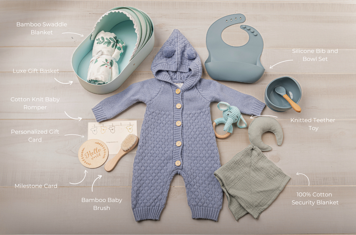 Baby clothing and accessories including a knitted romper, bib, and security blanket on a neutral background.