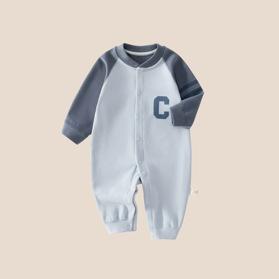 Cotton Craft Varsity C baby romper in soft blue with contrast long sleeves, varsity stripes and snap closure.