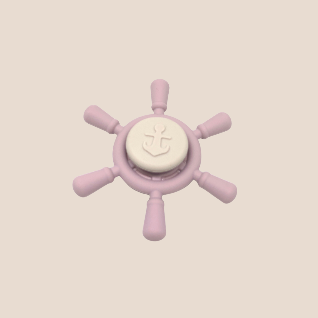 Cotton Craft blush pink silicone ship wheel sensory spinner baby toy with ivory anchor design