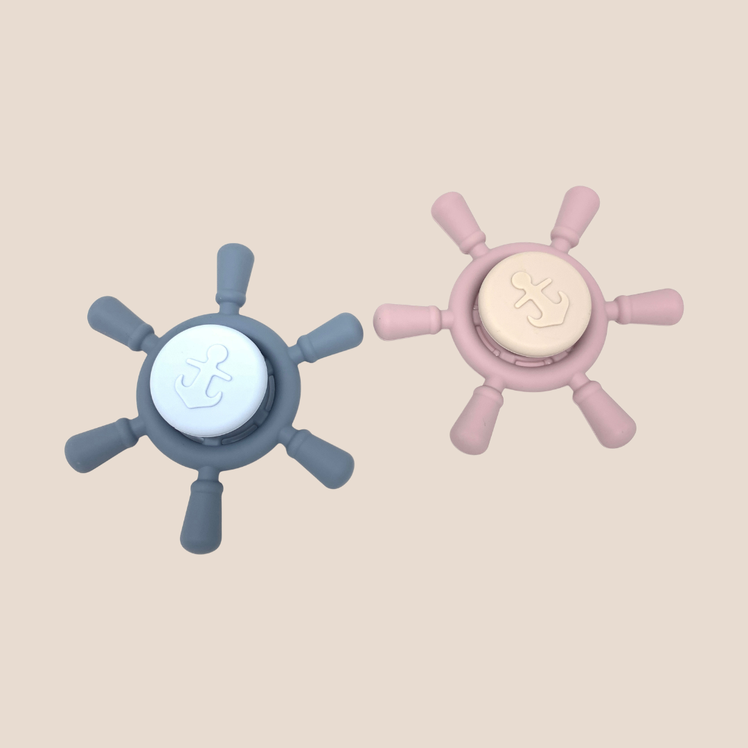 
Cotton Craft BPA-free silicone ship wheel sensory spinner toys in dusty blue and blush pink