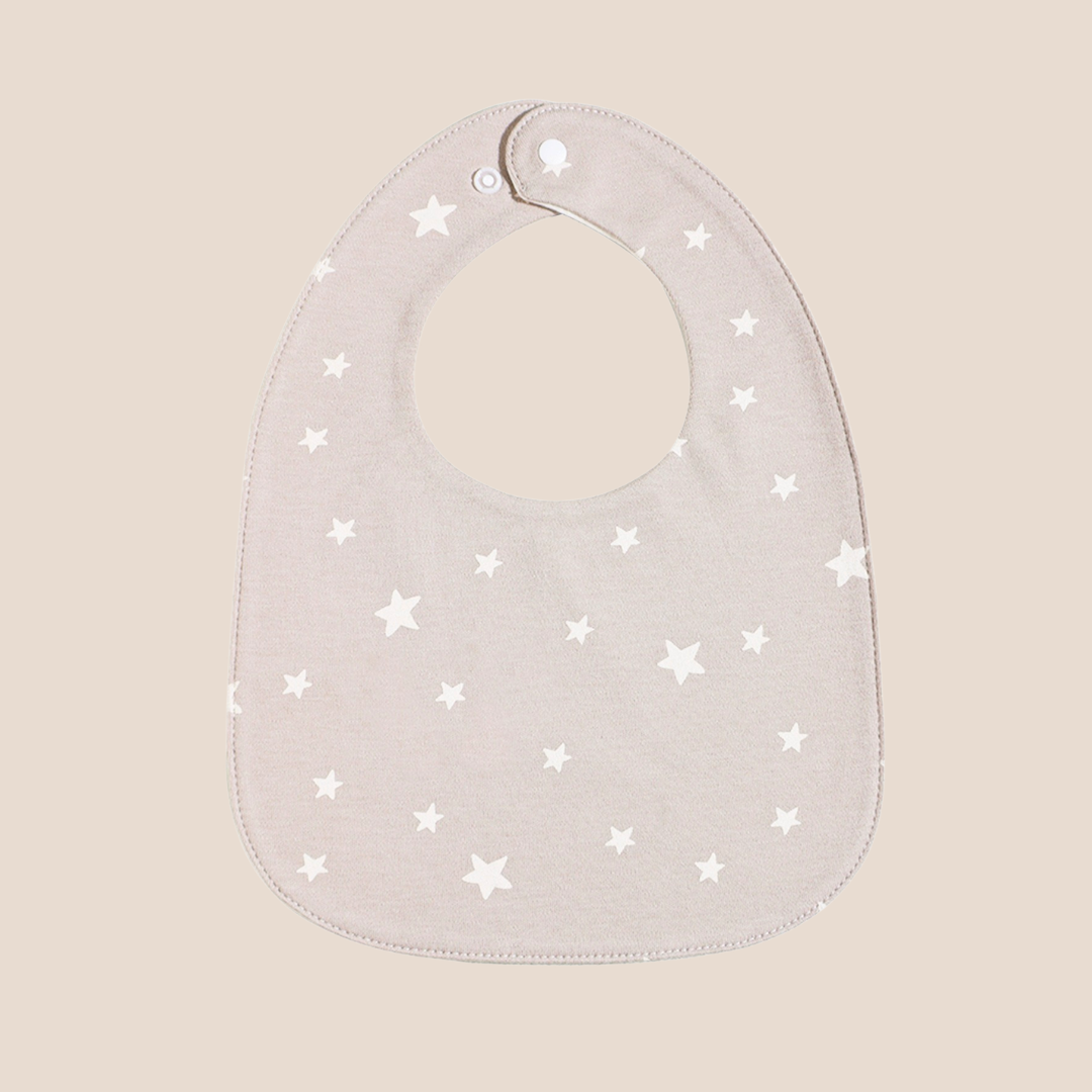 Cotton Craft Organic Cotton Muslin Baby Bib in Neutral Stars print with adjustable snap closure.