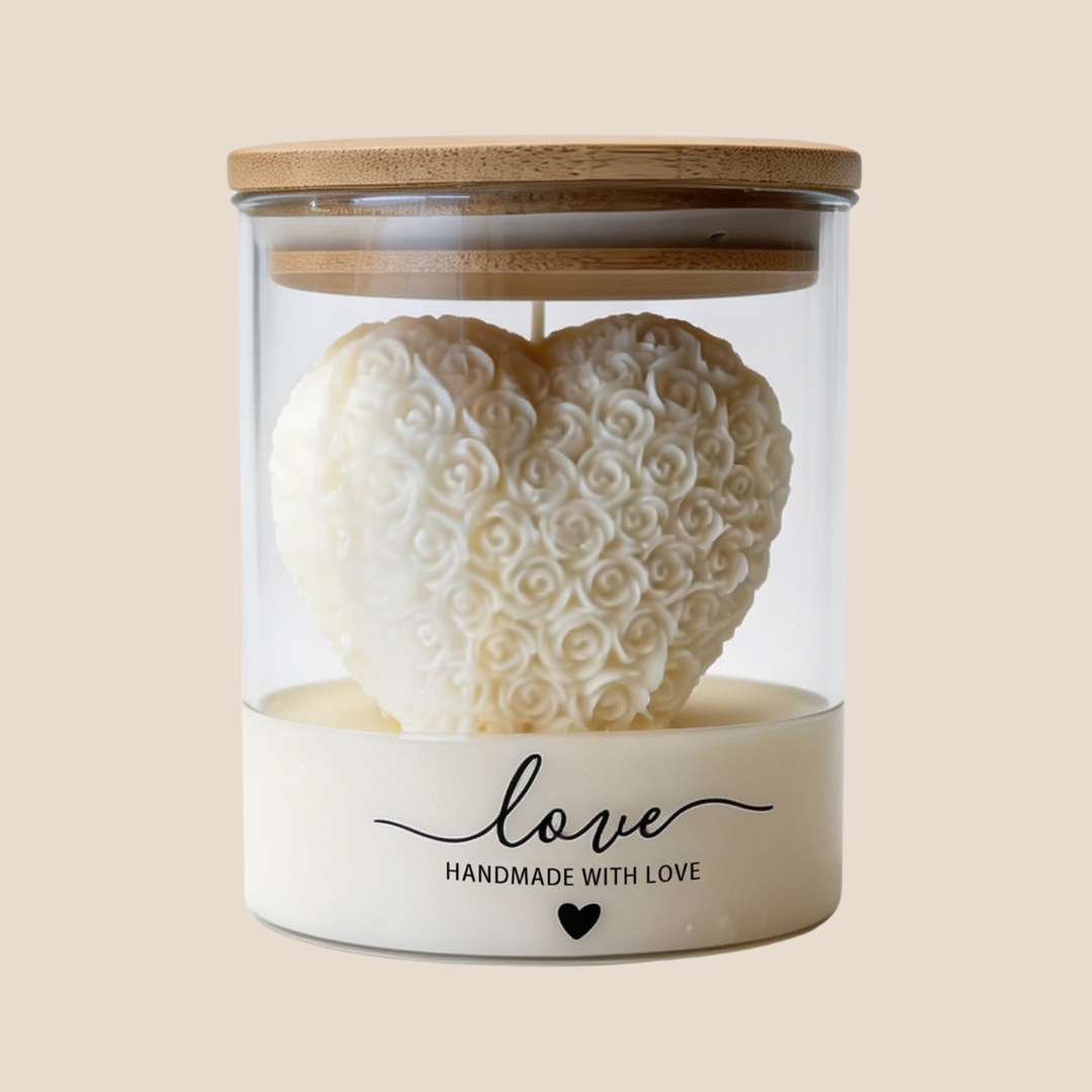 Handmade ivory rose heart soy wax candle displayed inside a clear glass jar with bamboo lid, luxury decorative candle gift for home décor and special occasions.
