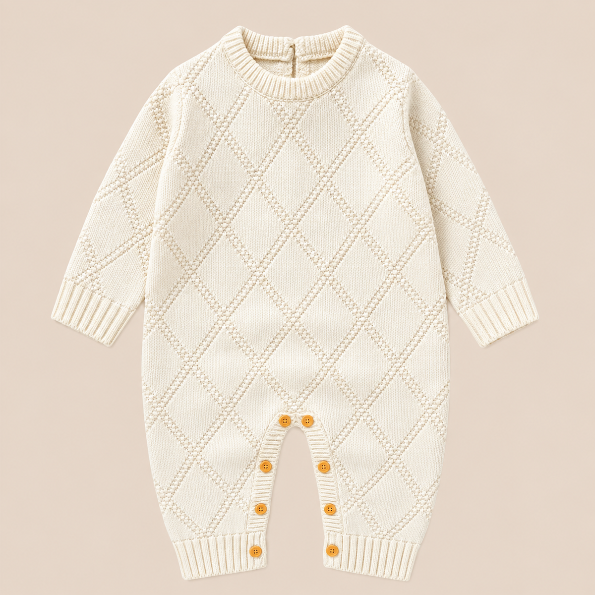 Ivory Little Heirloom knitted baby romper featuring raised diamond detailing and classic ribbed cuffs.