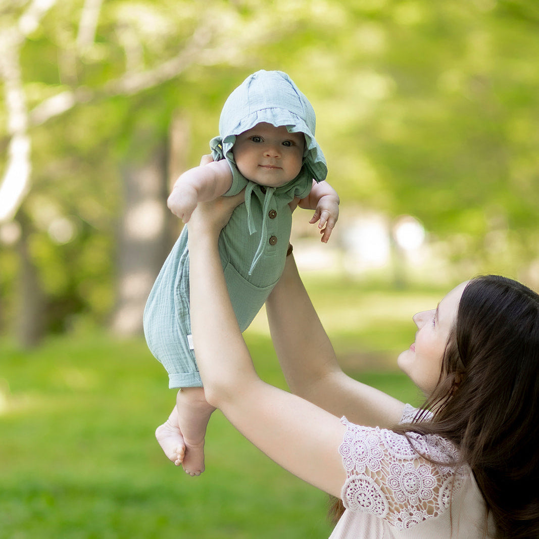Baby wearing cotton craft muslin cotton romper and cap set from cotton craft gift collection