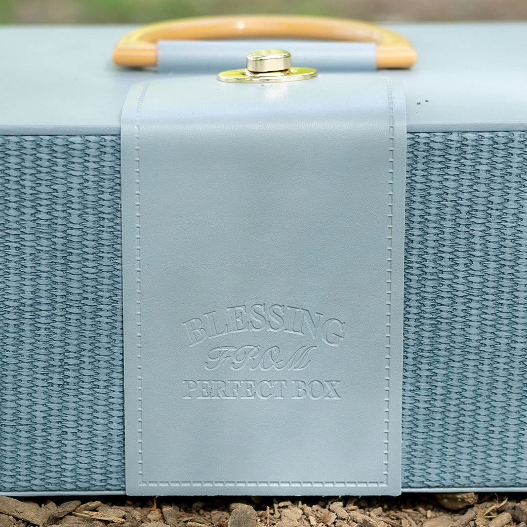 Blue woven box with a wooden handle on a natural background